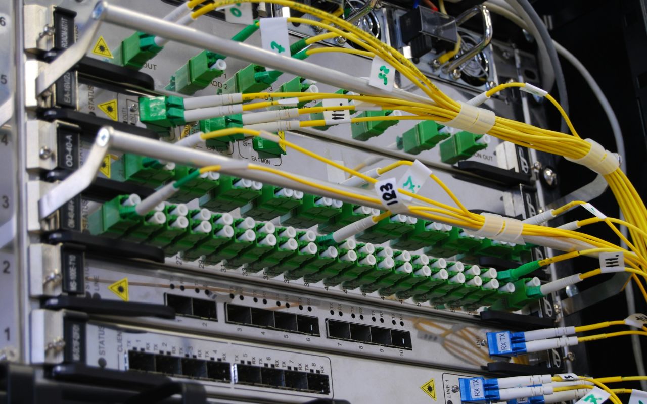 Fiber optic cables connected to a network switch in a server rack