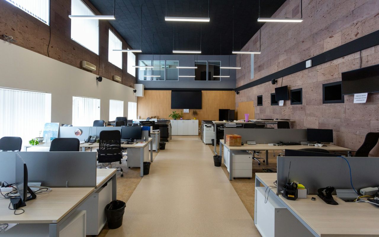 An open plan office with rows of desks and computers