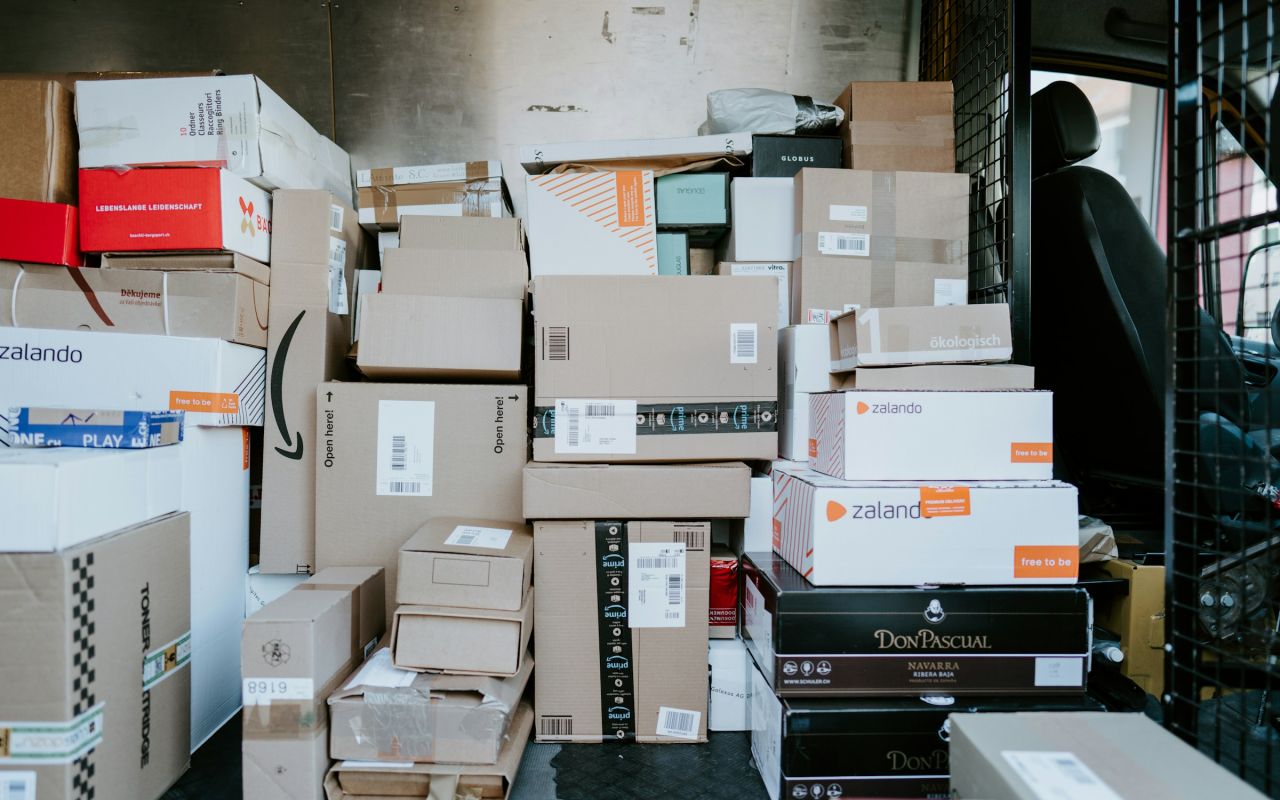 Cardboard shipping boxes stacked in the back of a delivery van