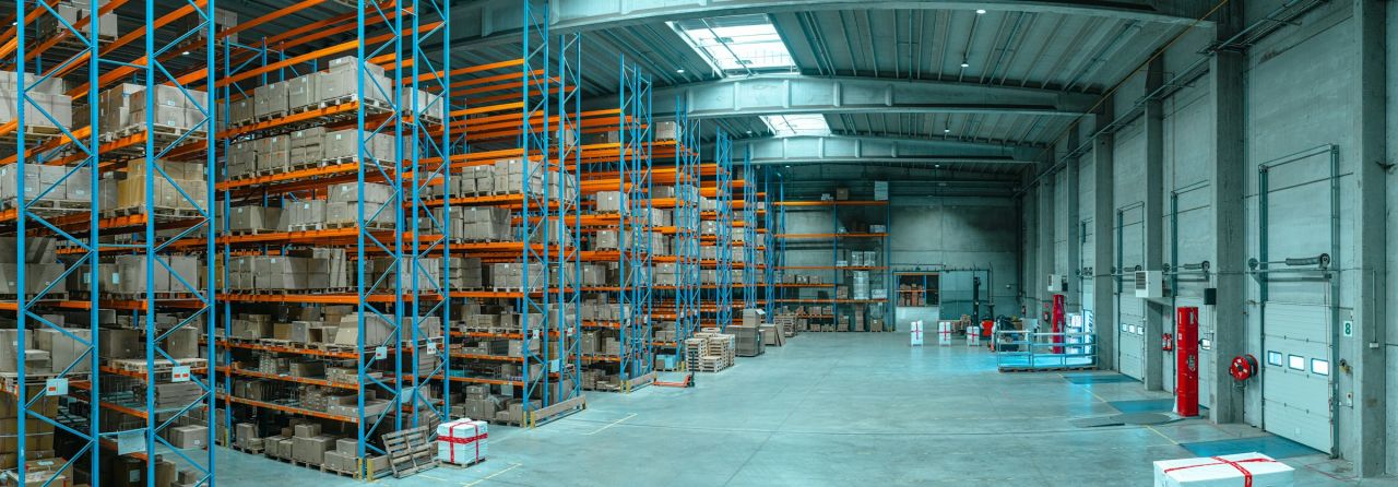 Tall shelving units filled with boxes in a large warehouse