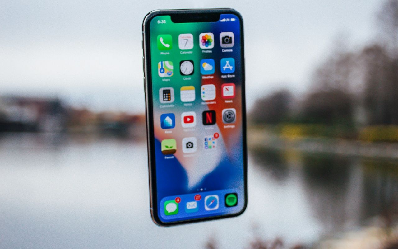A smartphone held above an open palm
